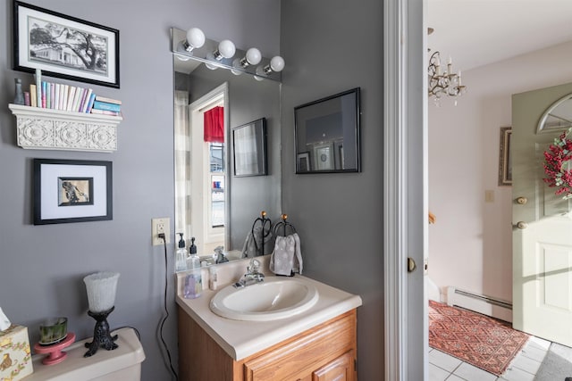 bathroom featuring toilet, a notable chandelier, baseboard heating, tile patterned floors, and vanity