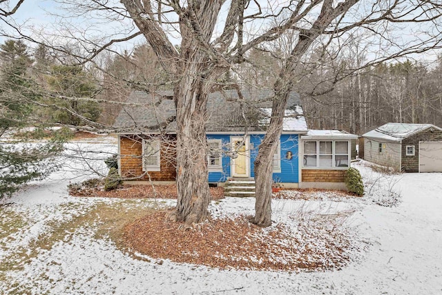 view of front of property with a garage and an outbuilding