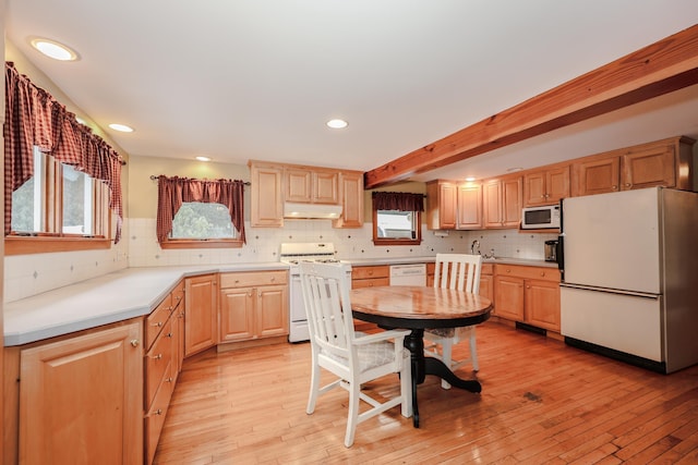 kitchen featuring white appliances, light brown cabinetry, decorative backsplash, beam ceiling, and light hardwood / wood-style flooring