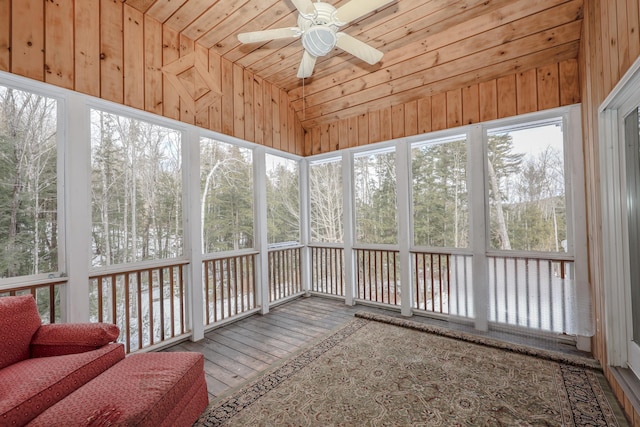 unfurnished sunroom with lofted ceiling, ceiling fan, and wooden ceiling