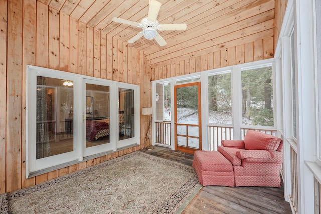 unfurnished sunroom featuring lofted ceiling, ceiling fan, and wood ceiling