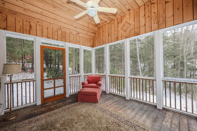 unfurnished sunroom featuring ceiling fan, vaulted ceiling, and wood ceiling