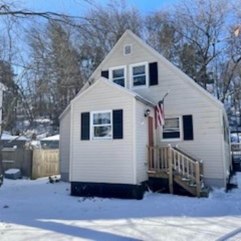 view of snow covered back of property