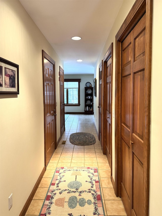 corridor with light tile patterned floors