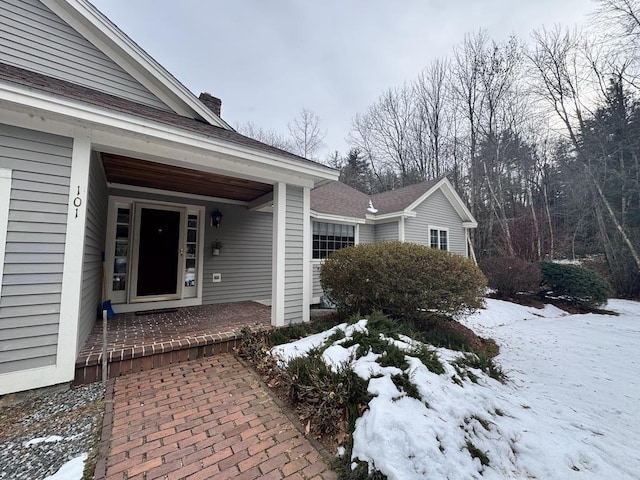 view of snow covered property entrance