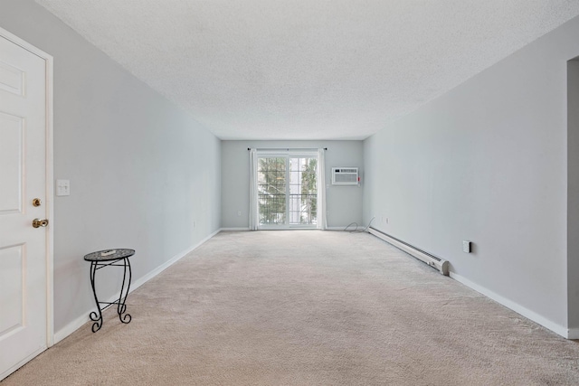 unfurnished room featuring a wall unit AC, a baseboard heating unit, a textured ceiling, and light colored carpet