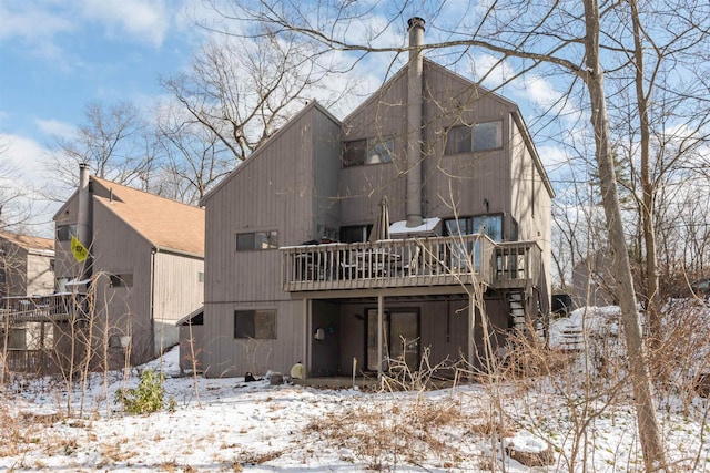 snow covered house with a deck