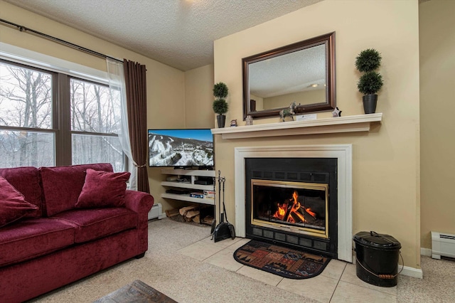 living room with a textured ceiling, baseboard heating, and light tile patterned floors