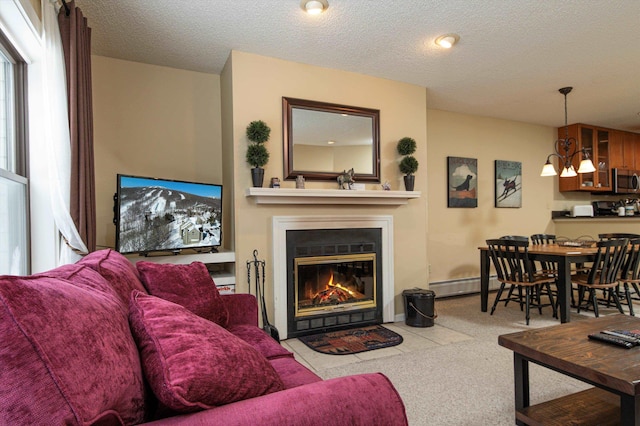 carpeted living room featuring a notable chandelier, baseboard heating, and a textured ceiling