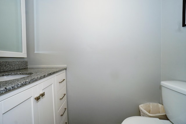 bathroom featuring toilet and vanity