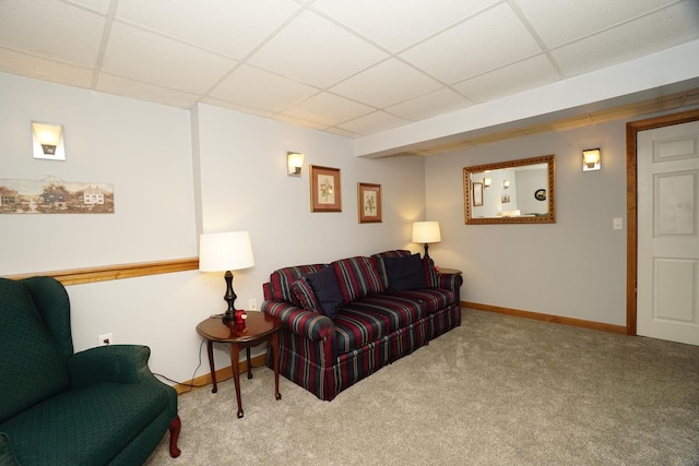 carpeted living room with a paneled ceiling