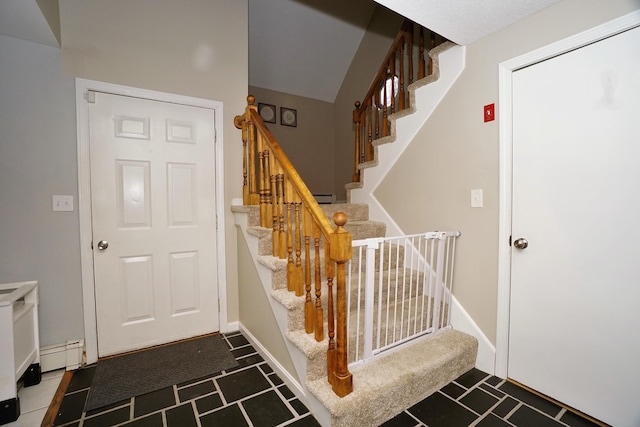 stairs featuring baseboard heating