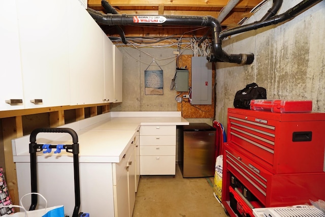 basement featuring electric panel and stainless steel fridge