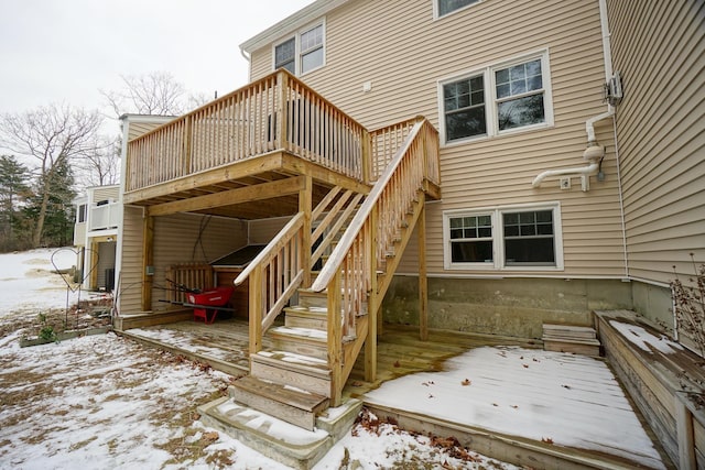 snow covered property with a deck