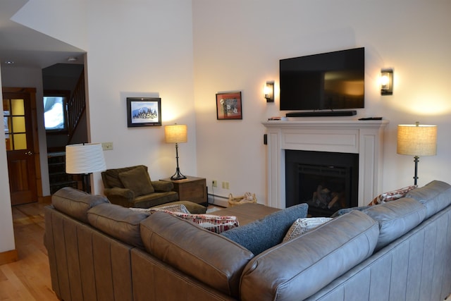 living room featuring light wood-type flooring and a baseboard radiator