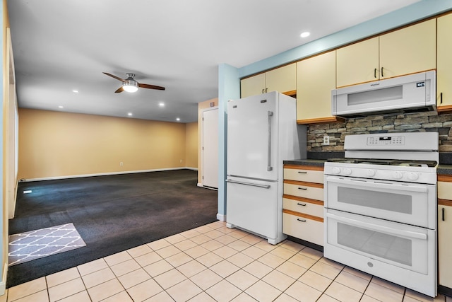 kitchen with white appliances, light carpet, cream cabinetry, ceiling fan, and tasteful backsplash