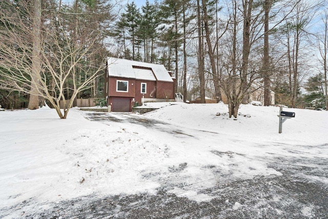 yard covered in snow featuring a garage