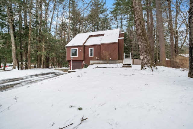 view of snow covered back of property