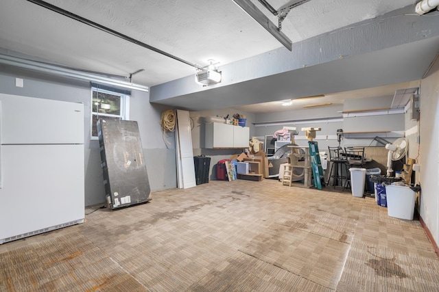 garage with white fridge and a garage door opener