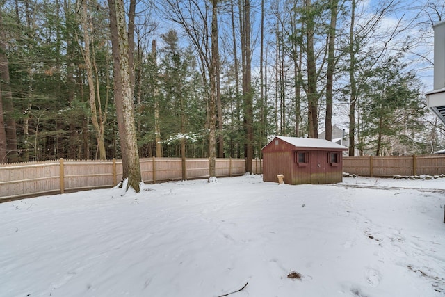 yard covered in snow with a storage unit