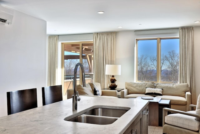 kitchen featuring an AC wall unit and sink