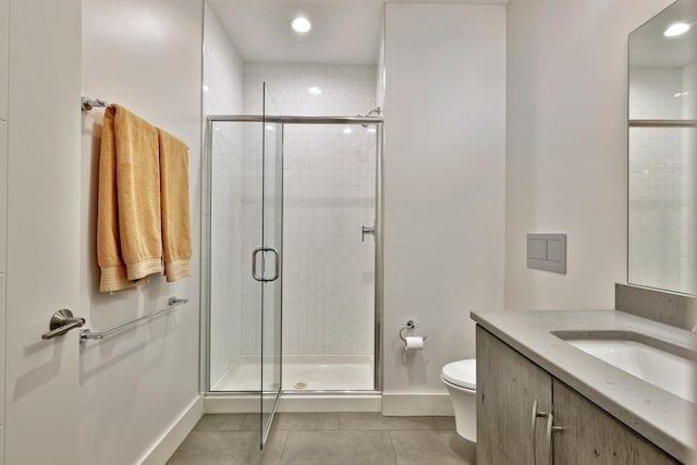 bathroom featuring tile patterned flooring, toilet, walk in shower, and vanity