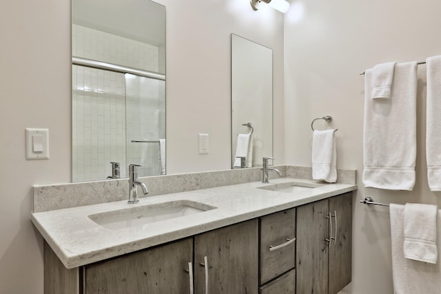 bathroom featuring walk in shower and vanity