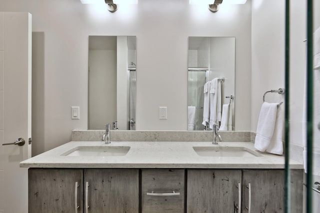 bathroom featuring an enclosed shower and vanity