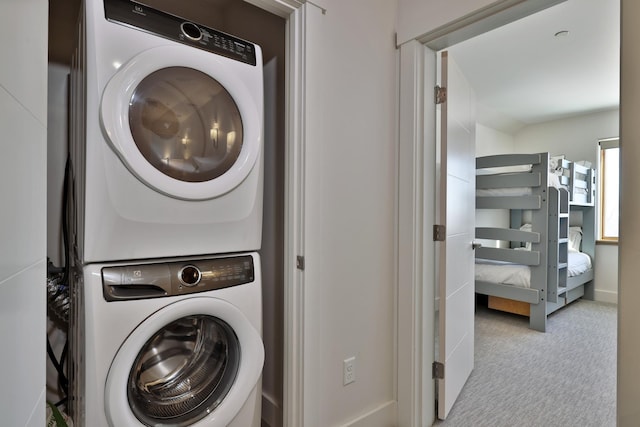 washroom with stacked washer / dryer and light colored carpet