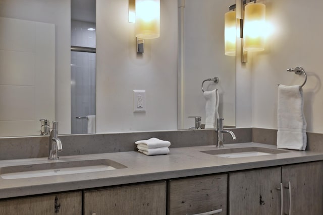 bathroom featuring an enclosed shower and vanity