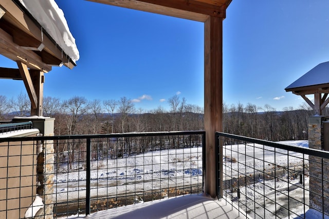 view of snow covered back of property