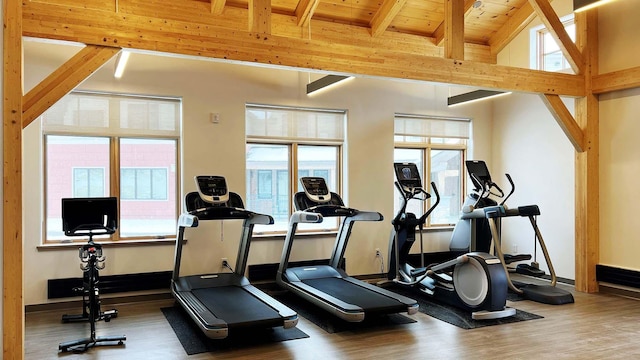 exercise room with wooden ceiling, lofted ceiling, and wood-type flooring