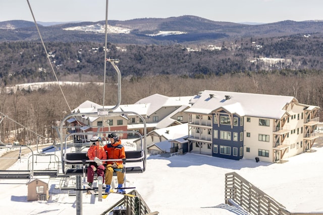 snowy aerial view with a mountain view