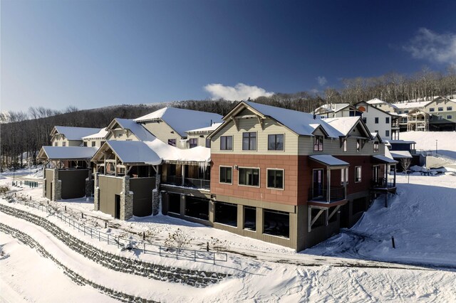 view of snow covered rear of property