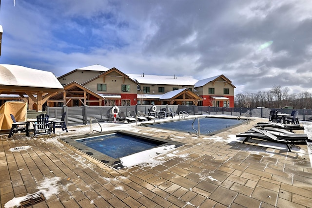 view of swimming pool with a jacuzzi and a patio