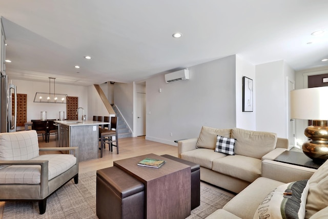 living room with light hardwood / wood-style floors and a wall mounted AC