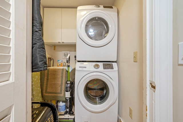 laundry room featuring stacked washer and clothes dryer