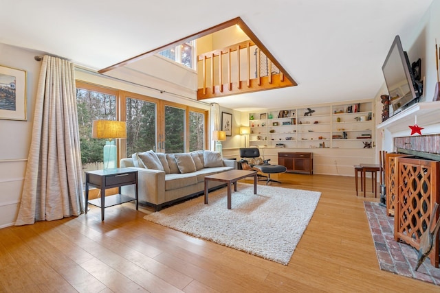 living room featuring light hardwood / wood-style floors and built in features