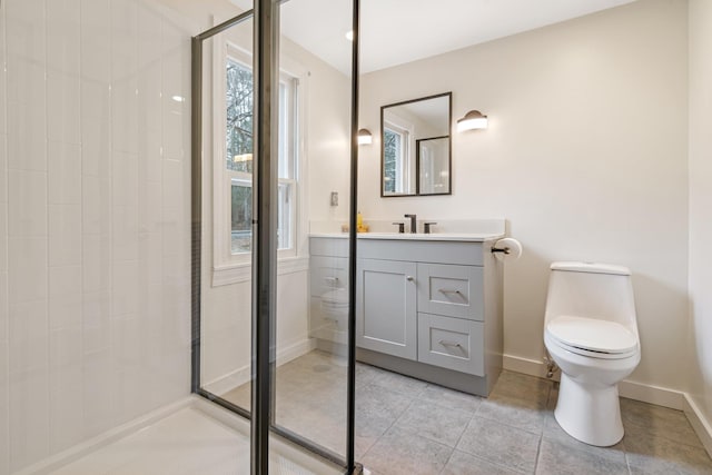 bathroom featuring toilet, a shower with door, and vanity