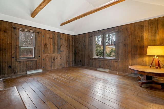 interior space with a baseboard radiator, vaulted ceiling with beams, and wood walls