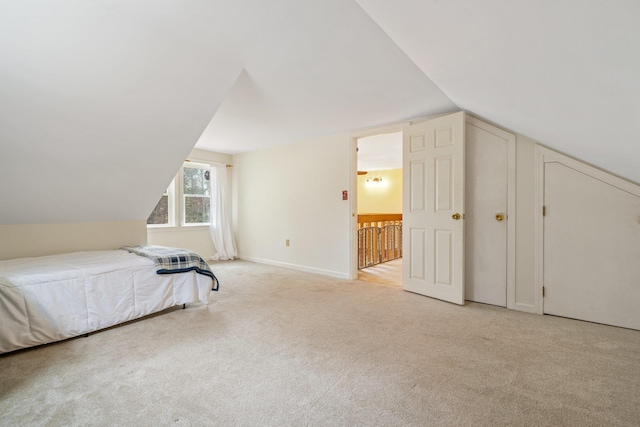 carpeted bedroom featuring vaulted ceiling