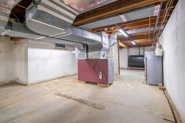 basement featuring water heater and heating unit