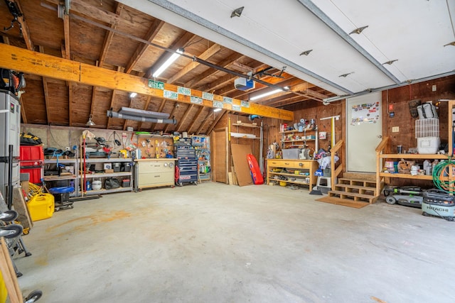 garage featuring a garage door opener and a workshop area