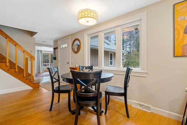 dining space with light hardwood / wood-style floors