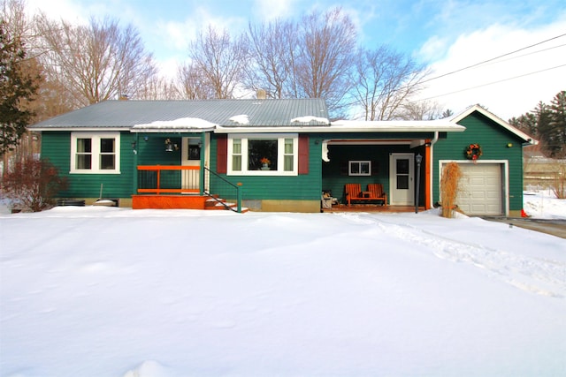 ranch-style home with a garage and covered porch