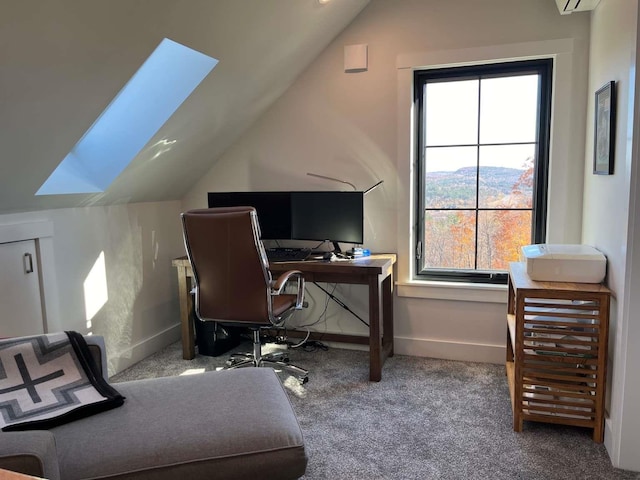 office area featuring vaulted ceiling with skylight and carpet