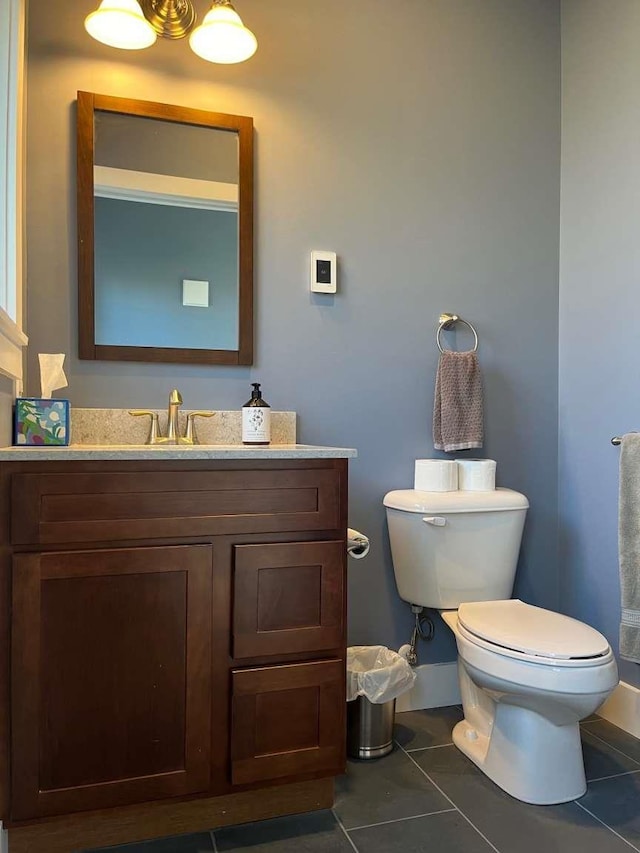 bathroom featuring toilet, tile patterned floors, and vanity