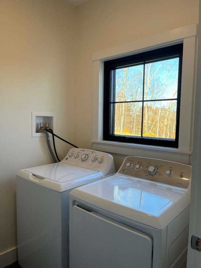 clothes washing area featuring separate washer and dryer