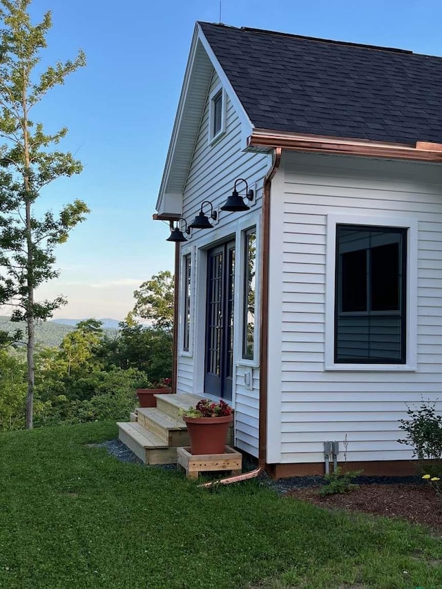 view of side of home featuring a lawn