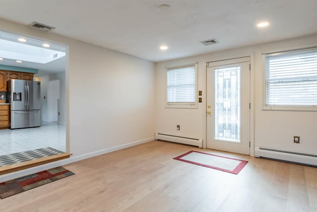 entryway featuring light hardwood / wood-style floors and baseboard heating